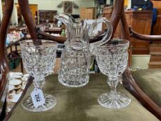 Large heavy cut glass jug with pair of goblets.