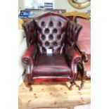 Thomas Lloyd ox blood buttoned leather wing armchair.