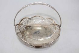 Silver pierced swing handle cake basket, 23cm diameter, Sheffield 1919.