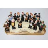 Collection of twenty two Royal Doulton Pickwick and other figures with stand.