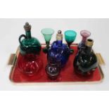 Three antique blue and green glass bottle decanters, coloured glass goblets, etc.