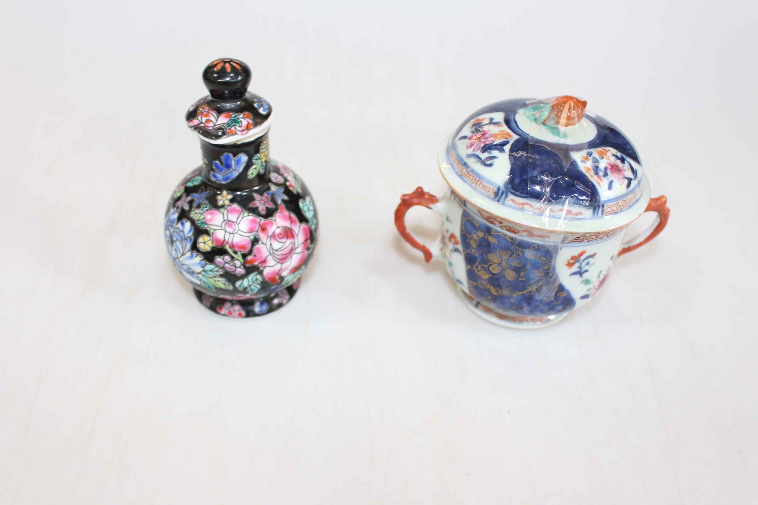 Small Chinese bottle with screw stopper in famille noir, and two handled cup and cover (2).