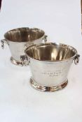Two large champagne ice buckets.