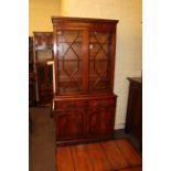 Mahogany cabinet bookcase having two astragal glazed doors above two drawers with cupboard doors