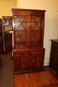 Mahogany cabinet bookcase having two astragal glazed doors above two drawers with cupboard doors