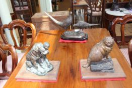 Three bronze sculptures comprising pair of pheasants, cat on wall and child with dog.