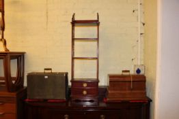 Two drawer open display stand and two vintage sewing machines.