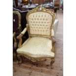 Pair gilt framed open armchairs in light gold fabric.