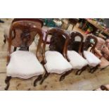 Set of four Victorian mahogany dining chairs with serpentine front seats.