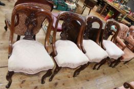 Set of four Victorian mahogany dining chairs with serpentine front seats.