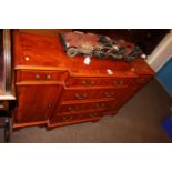 Yew breakfront side cabinet having four central drawers flanked by smaller drawers with cupboard