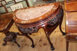 Oriental hardwood and mother of pearl inlaid demi-lune table with marble inset top on ball and claw