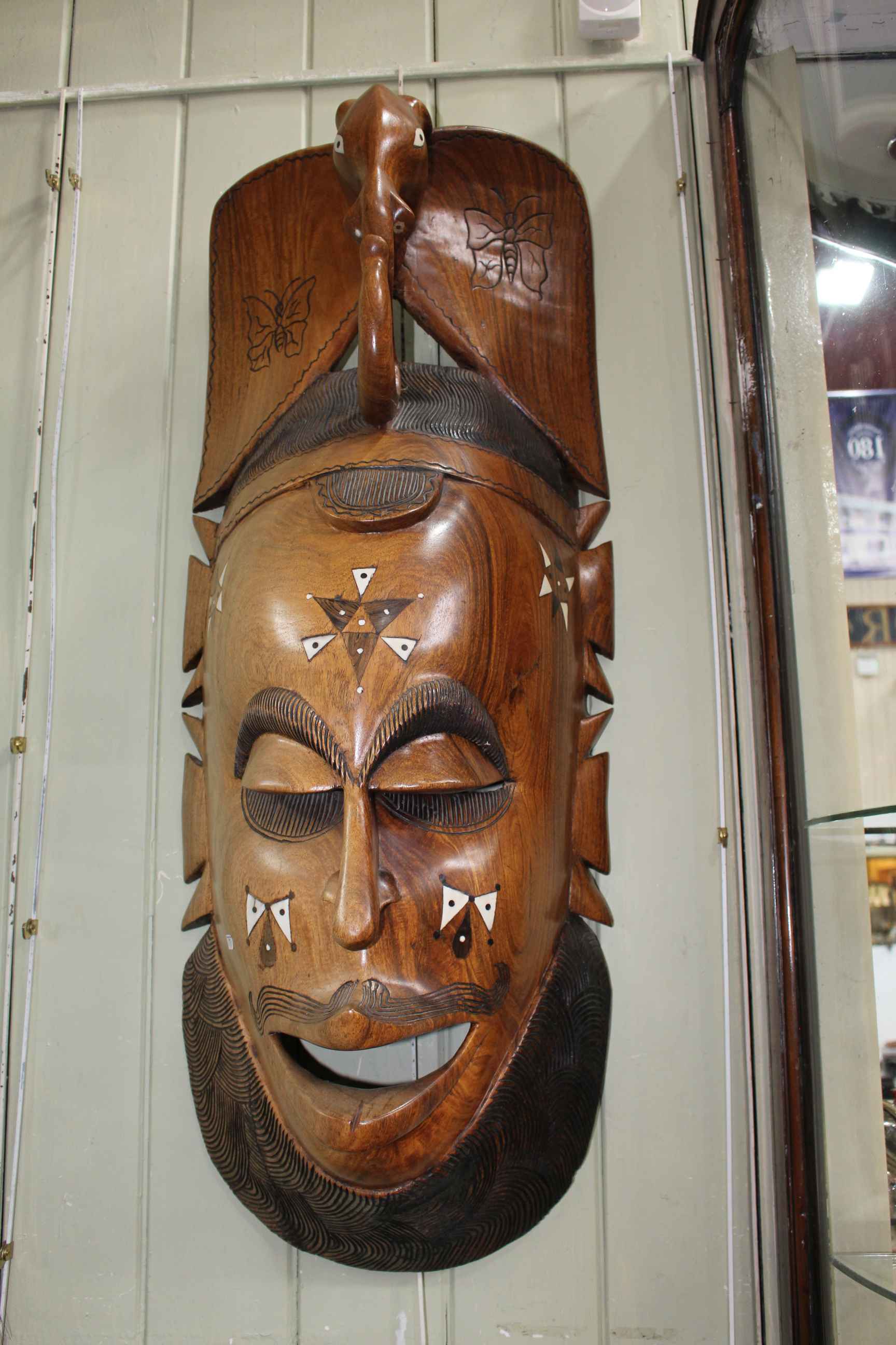 Large carved inlaid Zambian wall mask.