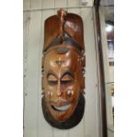 Large carved inlaid Zambian wall mask.