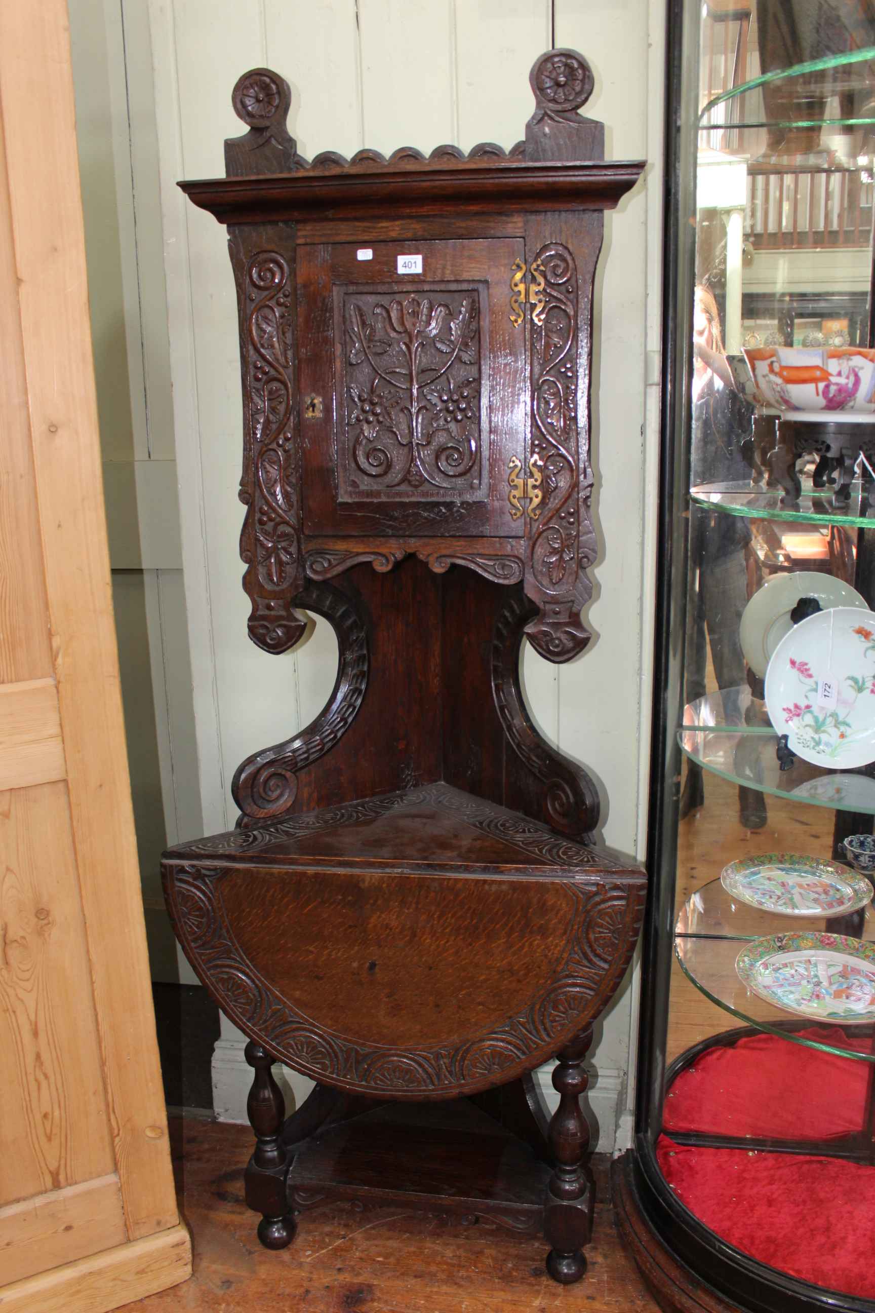 Victorian carved oak corner combination cabinet-drop leaf table, 176cm.