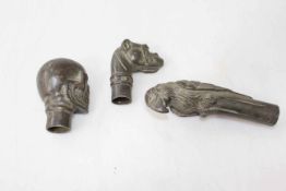 Three bronze coloured walking cane handles, skull, parakeet and hound.