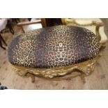 Large gilt framed oval stool in leopard skin print fabric.