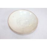 Chinese saucer dish with centre fish decoration, 17cm diameter.