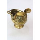 Late Victorian embossed brass coal helmet with ebony handles.