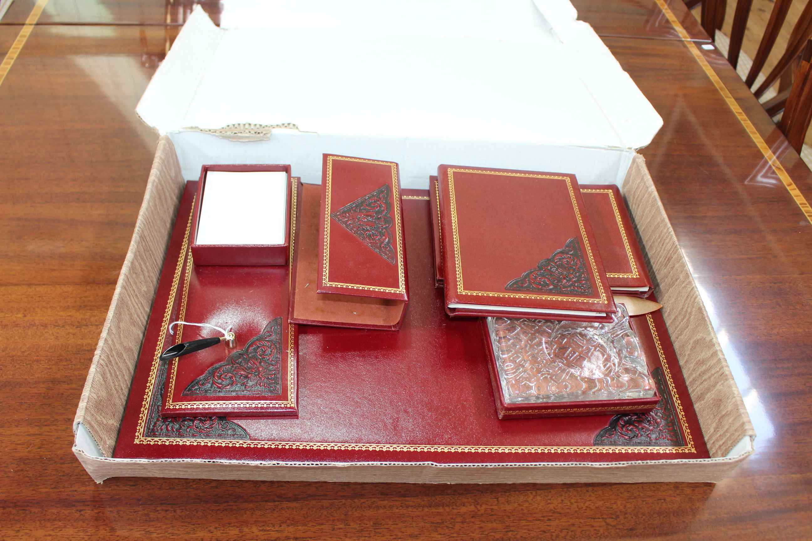 Gilt tooled and leather desk set with blotter, pen rest, notebooks, etc.