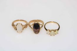 Three 9 carat gold rings set with opals, moonstone and blue john.