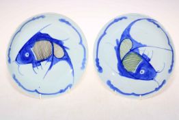 Pair Japanese blue and white fish saucer plates, 21cm diameter.