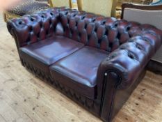 Ox blood buttoned leather two seater Chesterfield settee.
