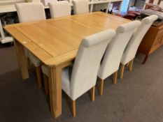 Rectangular light oak extending dining table with integral leaf and six dining chairs.