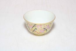 Small Chinese Famille Rose and bird decorated tea bowl with six character mark to base.