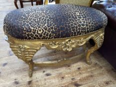 Large gilt framed oval stool in leopard skin print fabric.