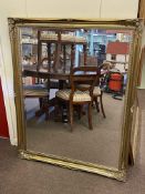 Rectangular gilt framed bevelled wall mirror, 131cm by 106cm including frame.