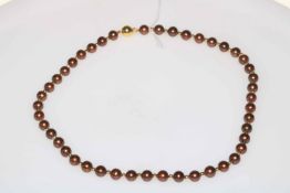 Bronze pearl and gold bead necklace, the clasp hallmarked 9 carat, 43cm length.