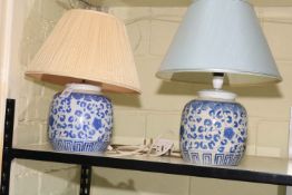 Pair of Chinese blue and white floral decorated table lamps with shades.