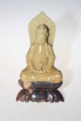 Malachite stone figure of seated Goddess on stand.