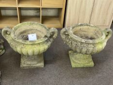 Pair weathered two handled pedestal garden urns, 49cm.
