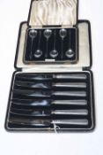 Case of silver handled knives and case of silver spoons (2).