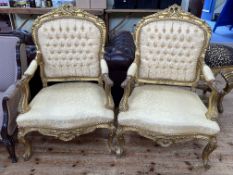 Pair gilt framed open armchairs in light gold fabric.