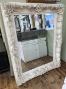 Large white painted ornate framed bevelled wall mirror, 156cm by 126cm including frame.
