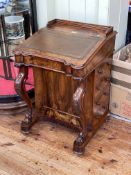Victorian burr walnut four drawer Davenport having shaped front raised on scrolled supports,