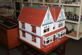 Large Elizabethan style dolls house with electrics on portable stand.