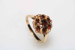 Garnet seven stone cluster 9 carat gold ring, size Q.