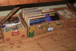 Four boxes of LP records and singles.