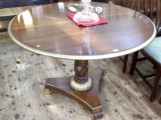 Empire style mahogany and gilt painted circular loo table on pedestal triform base,