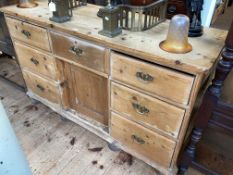 Victorian pine dresser having seven drawers and inset cupboard door, 79cm by 134.5cm by 46.5cm.