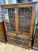 Old Charm oak cabinet having two leaded glazed doors above two carved panel cupboard doors,