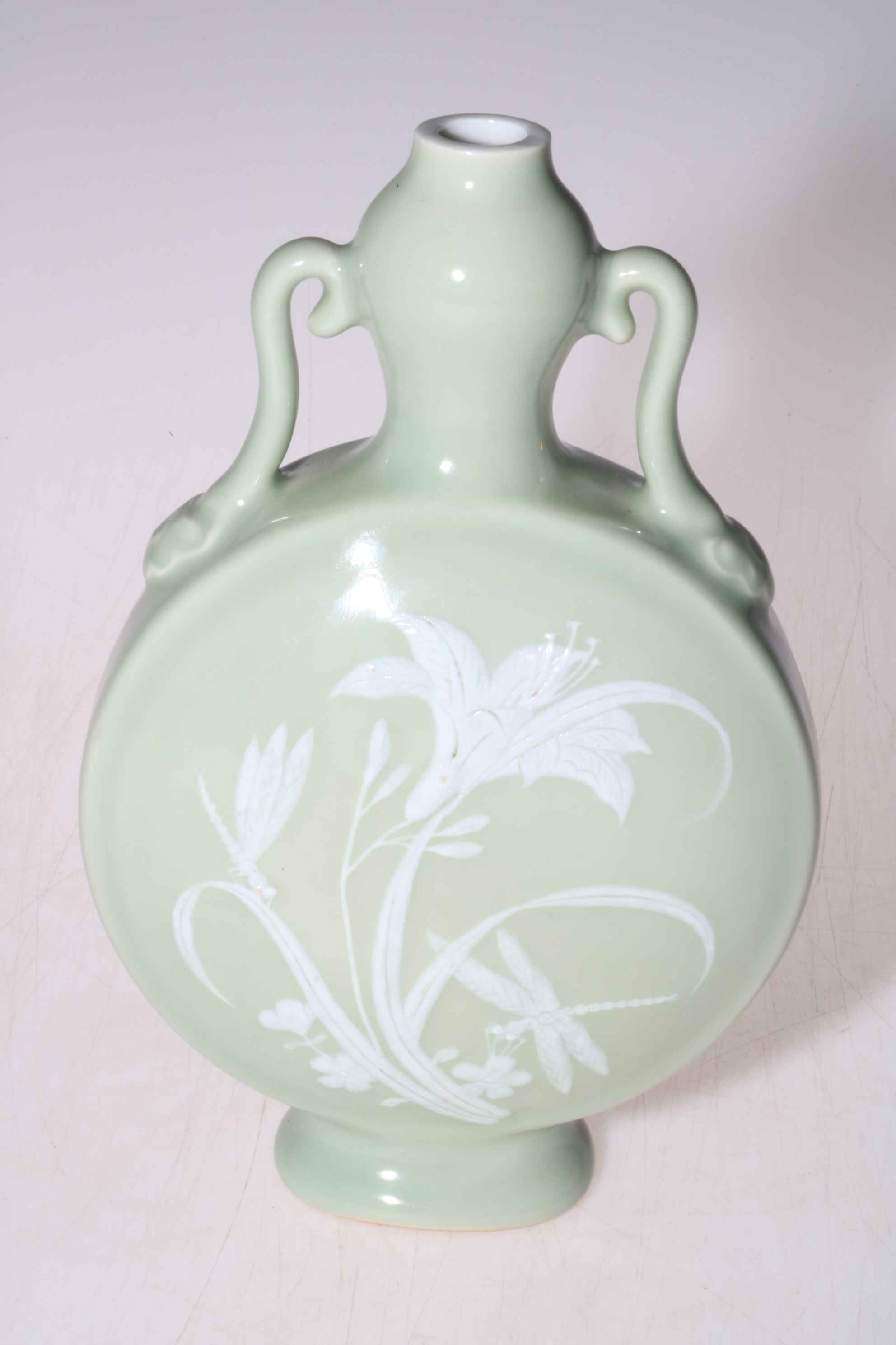 Chinese moon flask twin handled vase with floral pattern on pale ground, 21cm high.