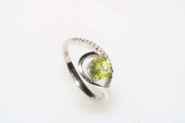 Peridot and 9 carat white gold dress ring, size N.