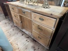 Victorian pine dresser having seven drawers and inset cupboard door, 79cm by 134.5cm by 46.5cm.