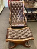 Brown buttoned leather scroll armchair and matching footstool.