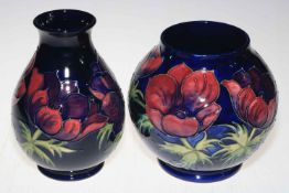 Two Moorcroft Pottery vases decorated with anemone on blue ground, tallest 19cm.